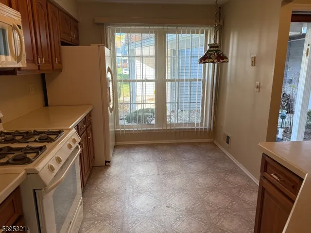 a kitchen with a stove and a refrigerator