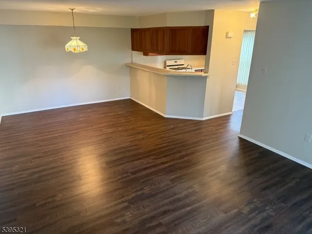 a view of a refrigerator in kitchen and wooden floor