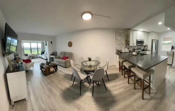 a living room with furniture and a floor to ceiling window