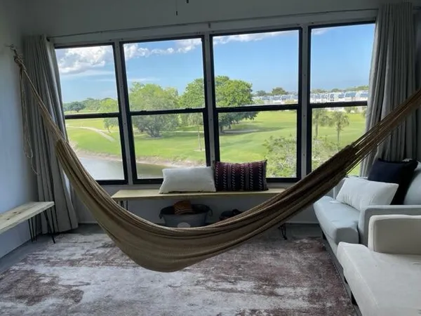 a living room with large window and a table