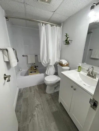 a bathroom with a toilet a sink and mirror