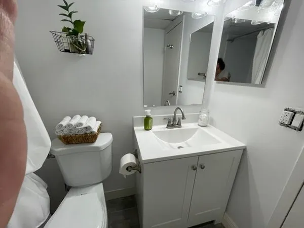 a bathroom with a toilet and a mirror