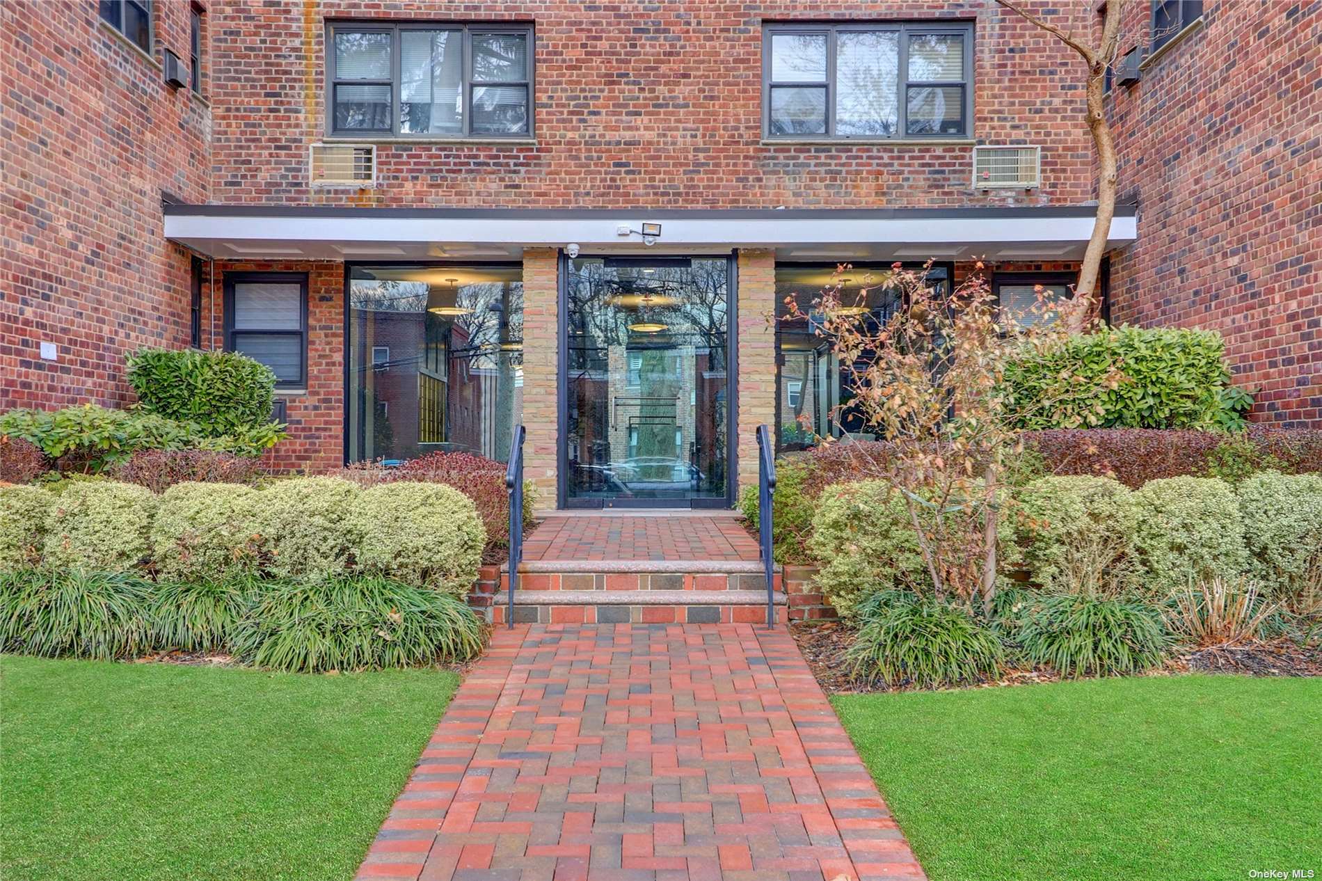 a front view of a building with garden