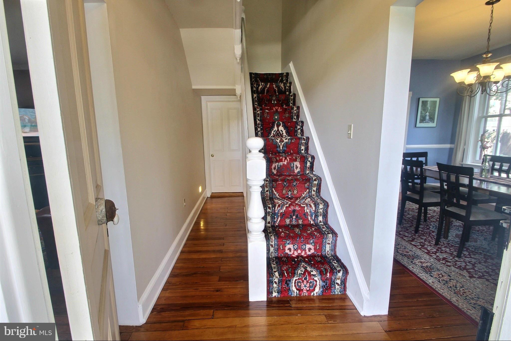 21404 Laytonsville Road Gaithersburg, MD 20882 - Photo 11 of 30 a view of a hallway with wooden floor and stairs