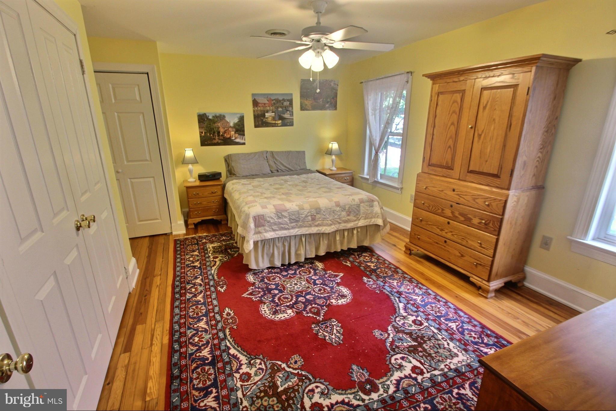 21404 Laytonsville Road Gaithersburg, MD 20882 - Photo 12 of 30 a bedroom with a bed and wooden floor