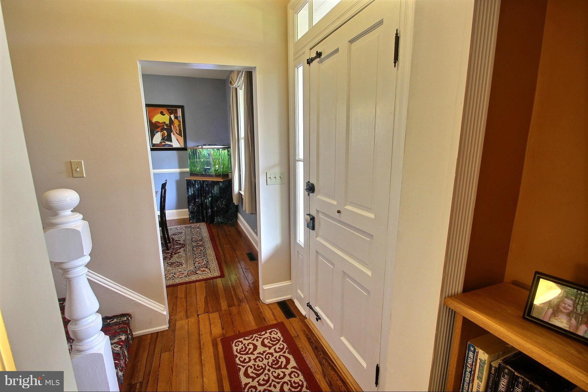 21404 Laytonsville Road Gaithersburg, MD 20882 - Photo 4 of 30 a view of a hallway with furniture and wooden floor