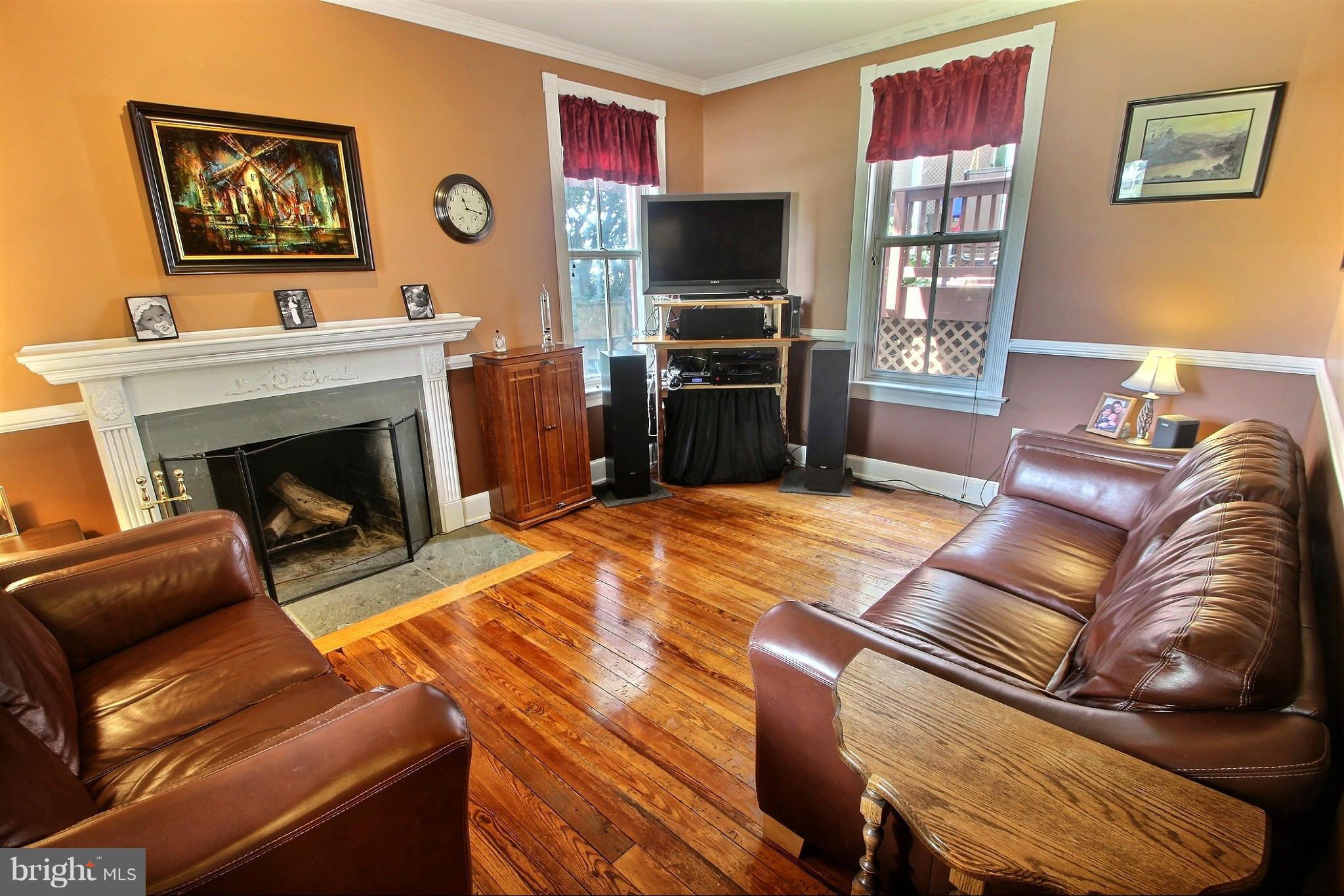 21404 Laytonsville Road Gaithersburg, MD 20882 - Photo 6 of 30 a living room with furniture a flat screen tv and a fireplace