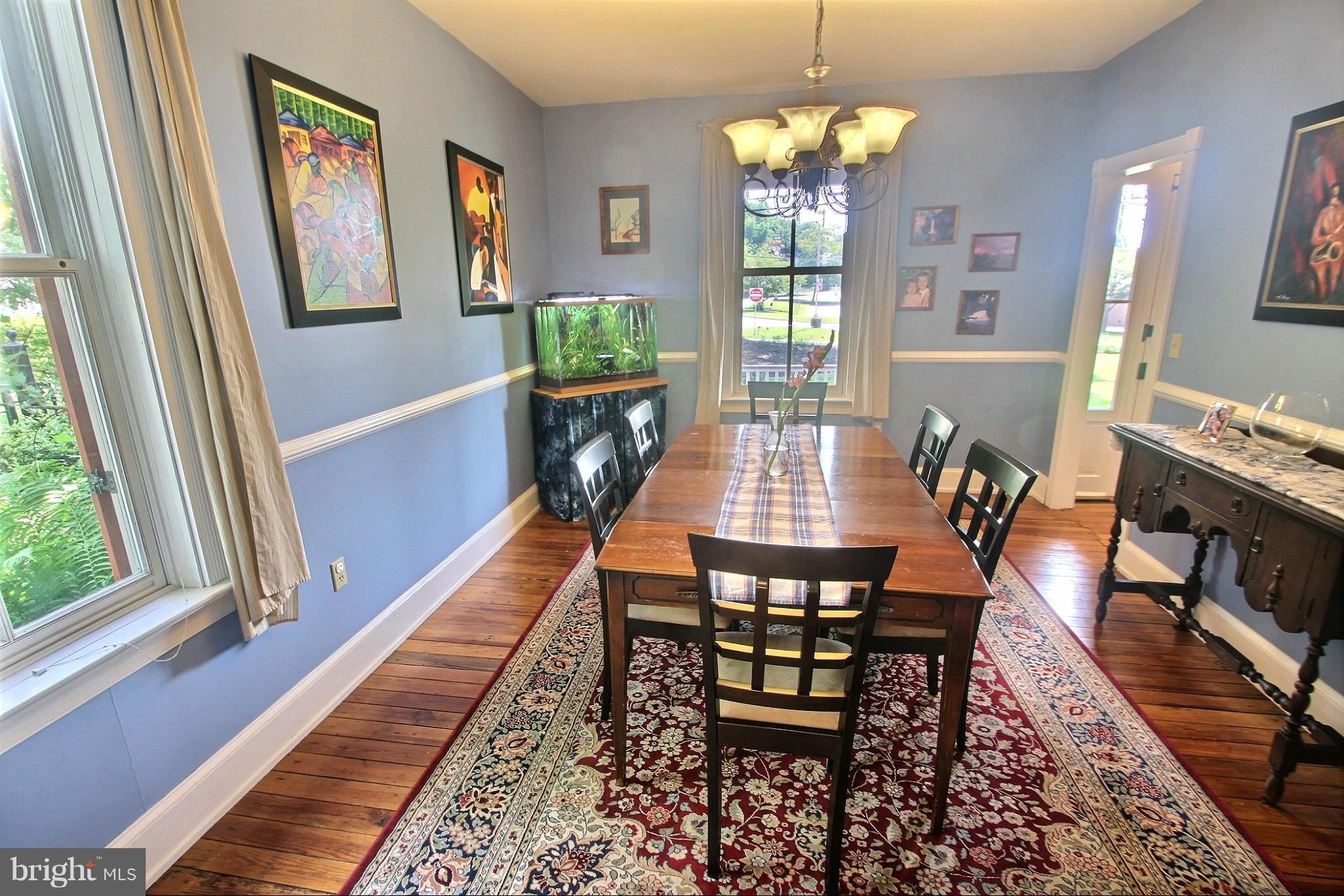 21404 Laytonsville Road Gaithersburg, MD 20882 - Photo 8 of 30 a dining room with furniture a rug a potted plant and a chandelier