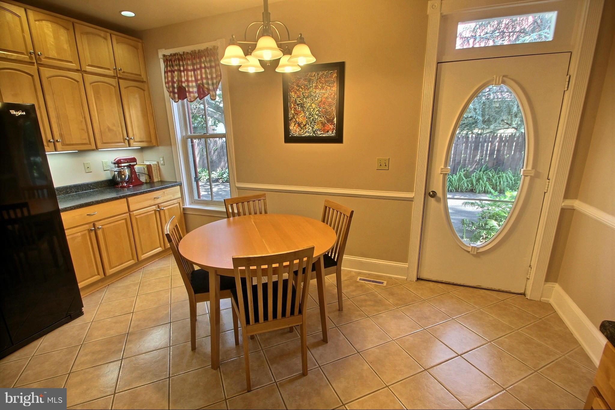 21404 Laytonsville Road Gaithersburg, MD 20882 - Photo 9 of 30 a dining room with furniture a window and a chandelier