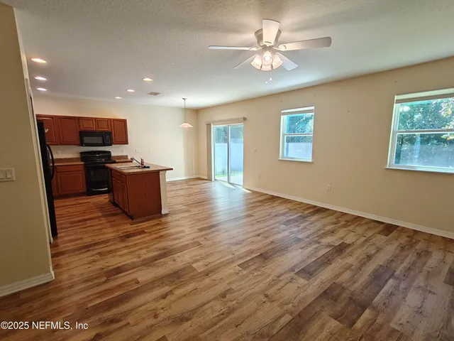a view of kitchen with granite countertop cabinets and wooden floor