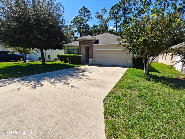 a view of a backyard with large trees