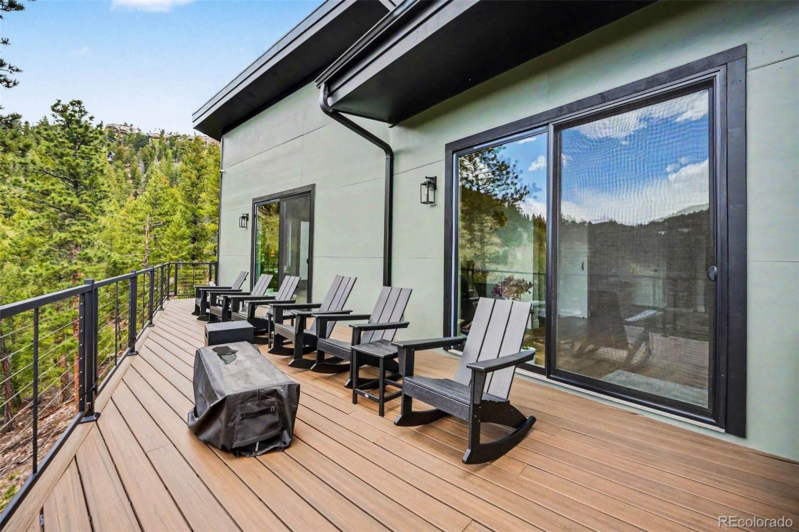 7231 Timber Trail Road Evergreen, CO 80439 - Photo 28 of 35 a balcony with wooden floor and outdoor seating