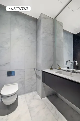 a bathroom with a sink a toilet and mirror