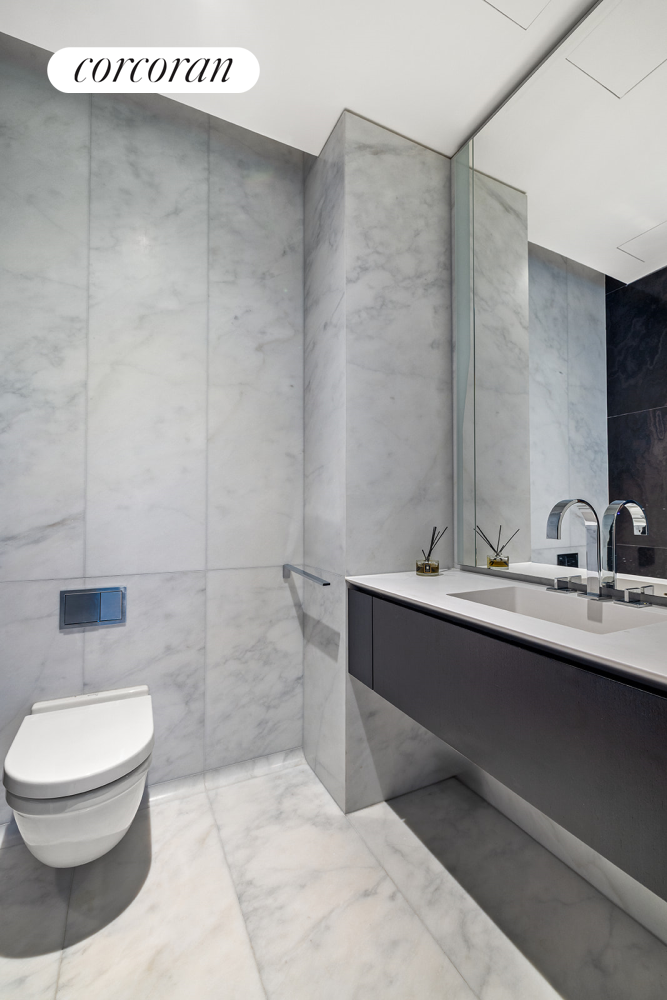 520 West 28th Street, Unit 29 Manhattan, NY 10001 - Photo 13 of 14 a bathroom with a sink a toilet and mirror