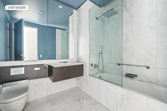 a spacious bathroom with a tub sink shower and mirror
