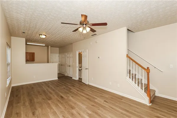 a view of an empty room with wooden floor