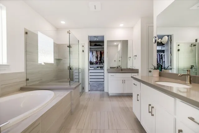 a large kitchen with a sink and stainless steel appliances