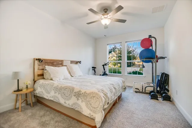 a bedroom with bed and a chandelier