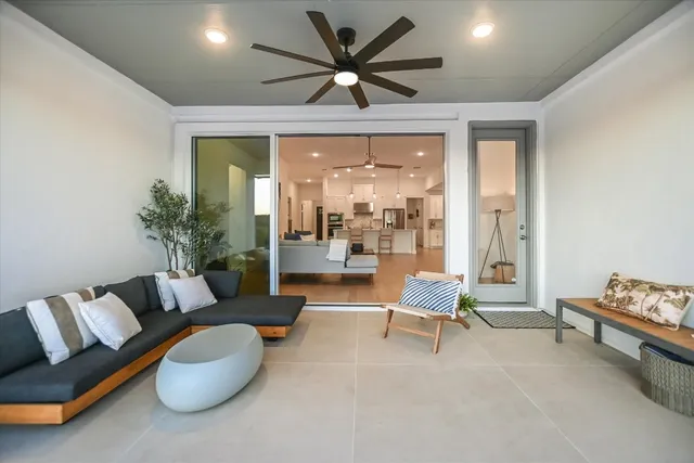 a living room with furniture and a large window with garden view