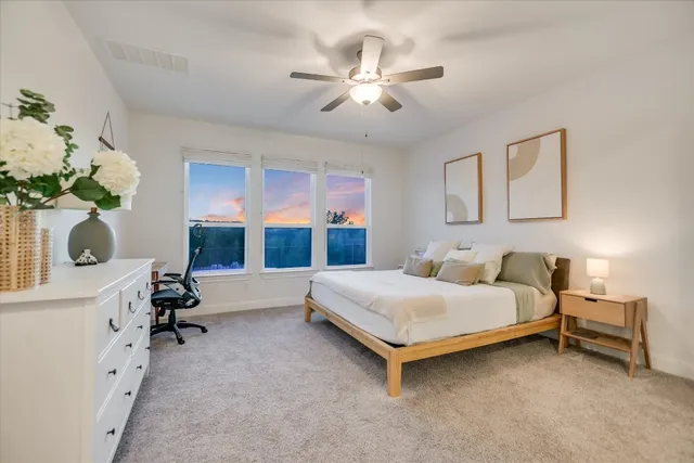a bedroom with a bed furniture and a chandelier