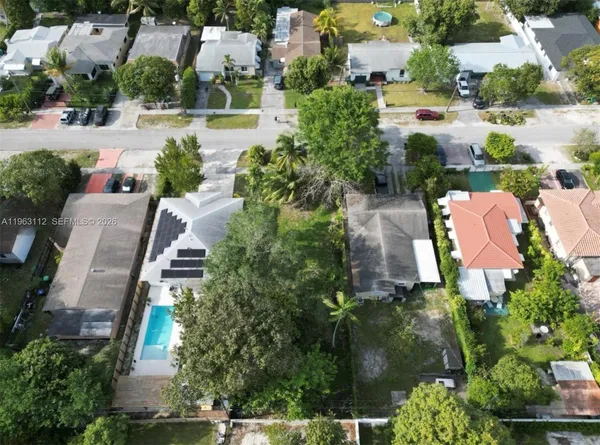 an aerial view of multiple houses with yard