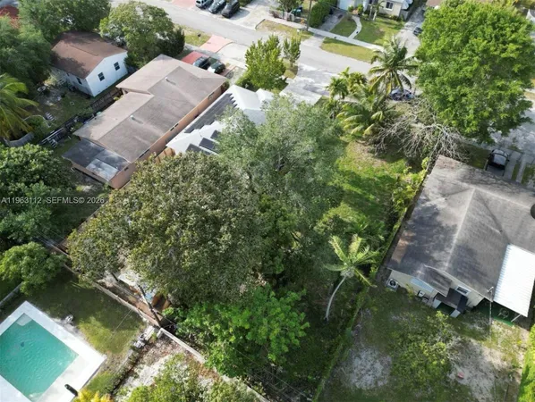 an aerial view of a house with a yard basket ball court and outdoor seating