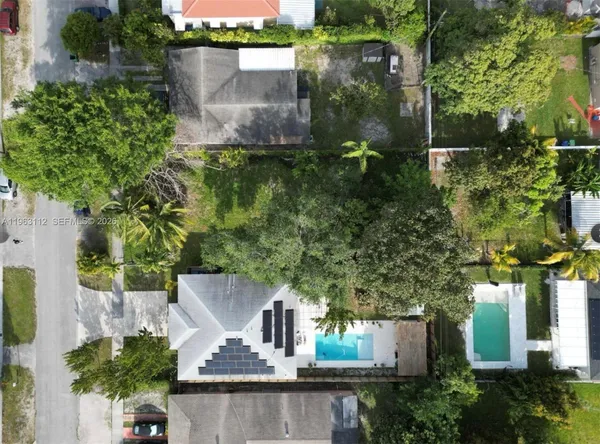 an aerial view of a house with a yard and garden