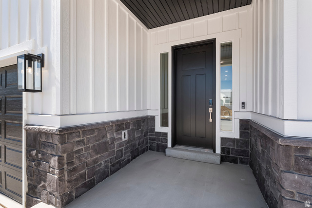 58 South Crimson Way, Unit 306 Mapleton, UT 84664 - Photo 3 of 24 Contemporary exterior featuring white vertical siding and dark stone veneer