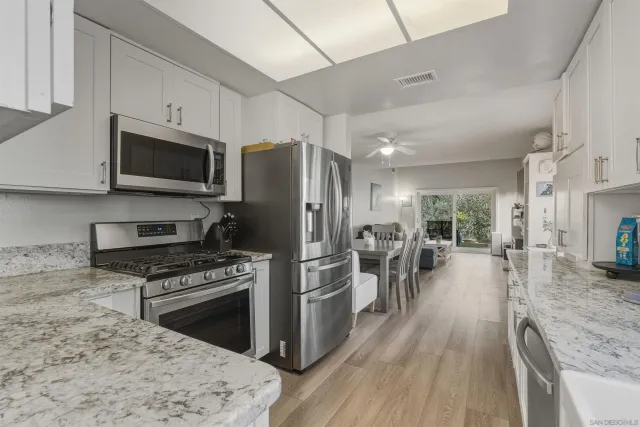 a kitchen with refrigerator a stove and cabinets