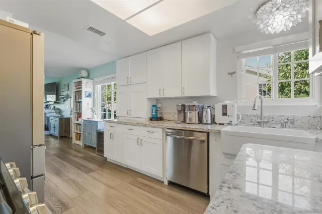 a kitchen with sink cabinets and window