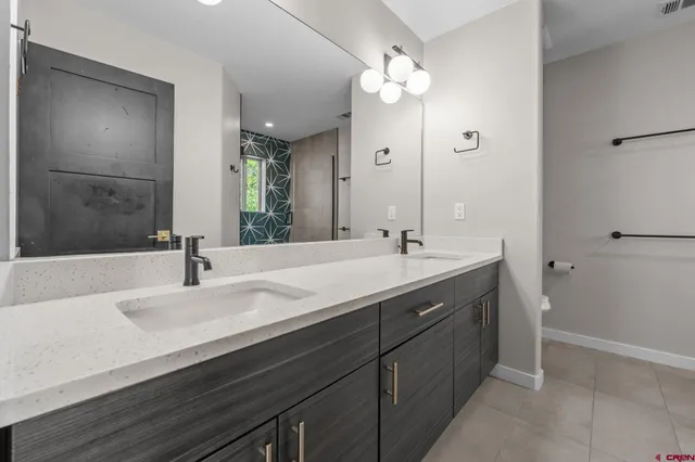 a bathroom with a sink double vanity and a mirror