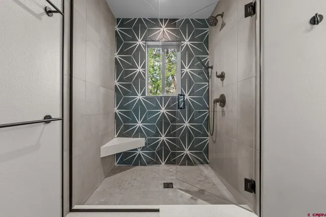 a view of an empty room with window and closet