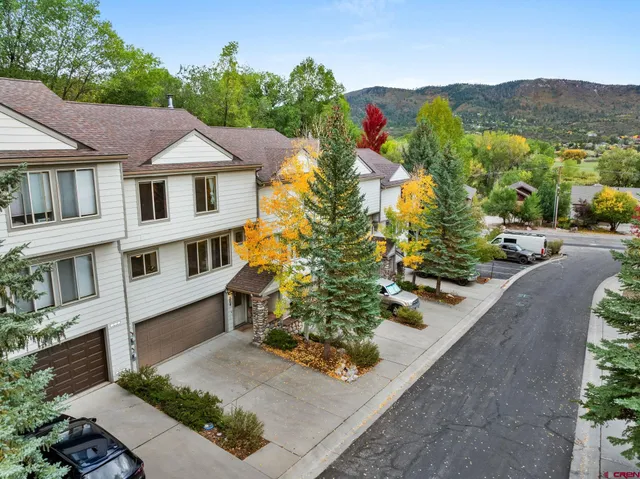 an aerial view of a house with a yard and garden
