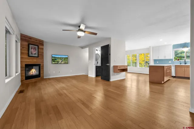 a view of a livingroom with a fireplace a microwave and furniture