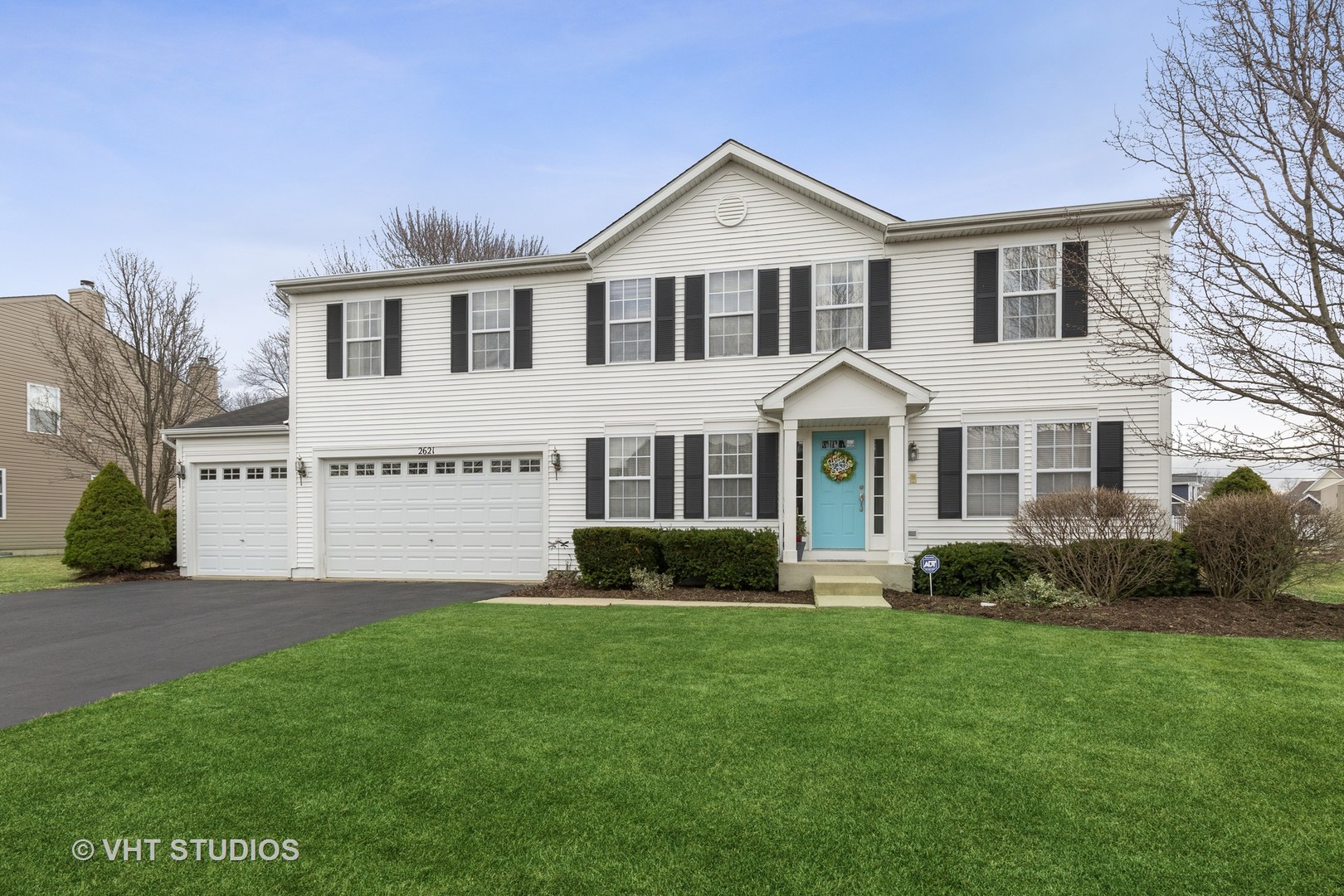 a front view of a house with a garden and plants