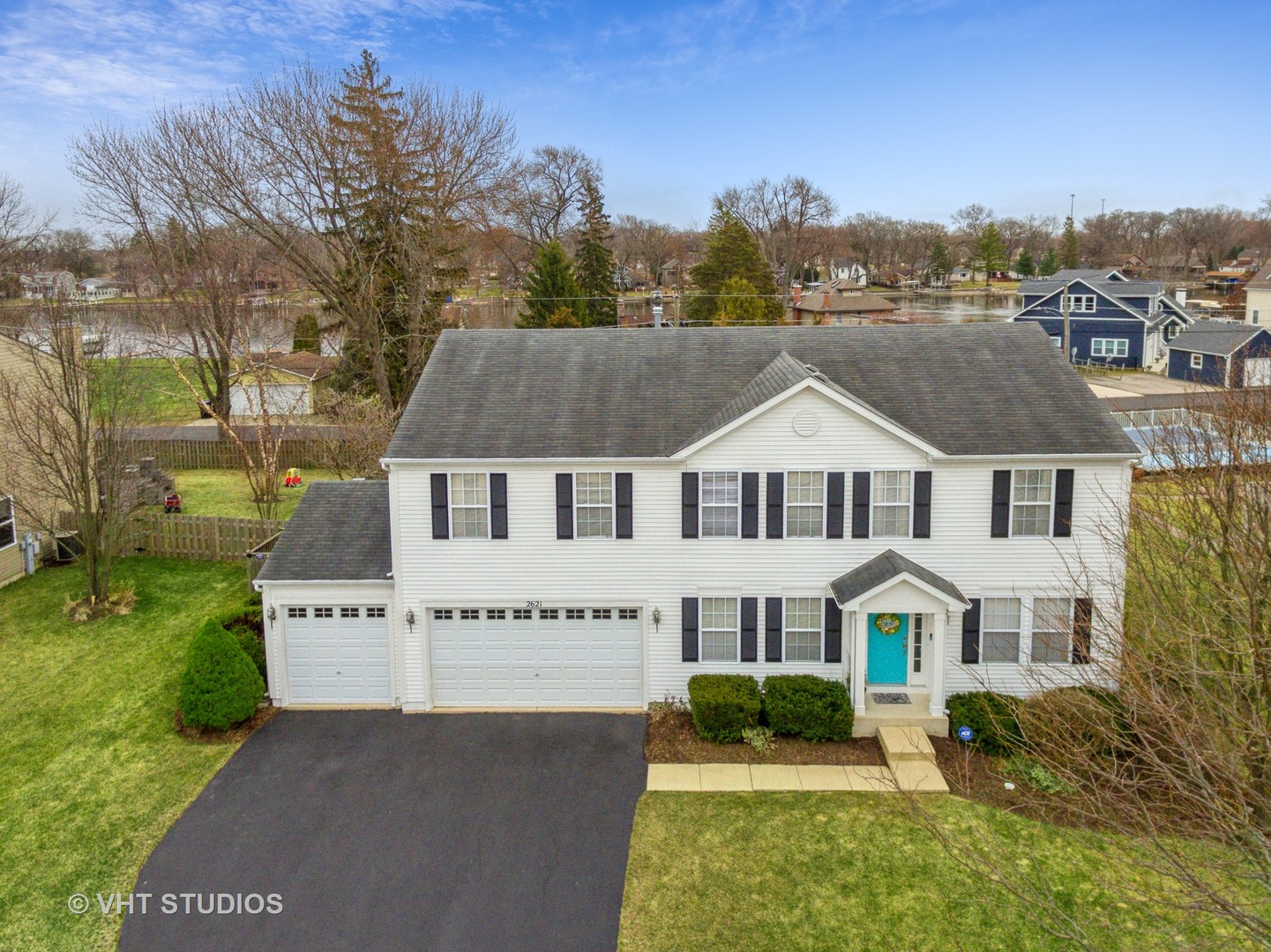 2621 Arbor Drive McHenry, IL 60050 - Photo 24 of 36 a view of a white house with a big yard plants and large trees