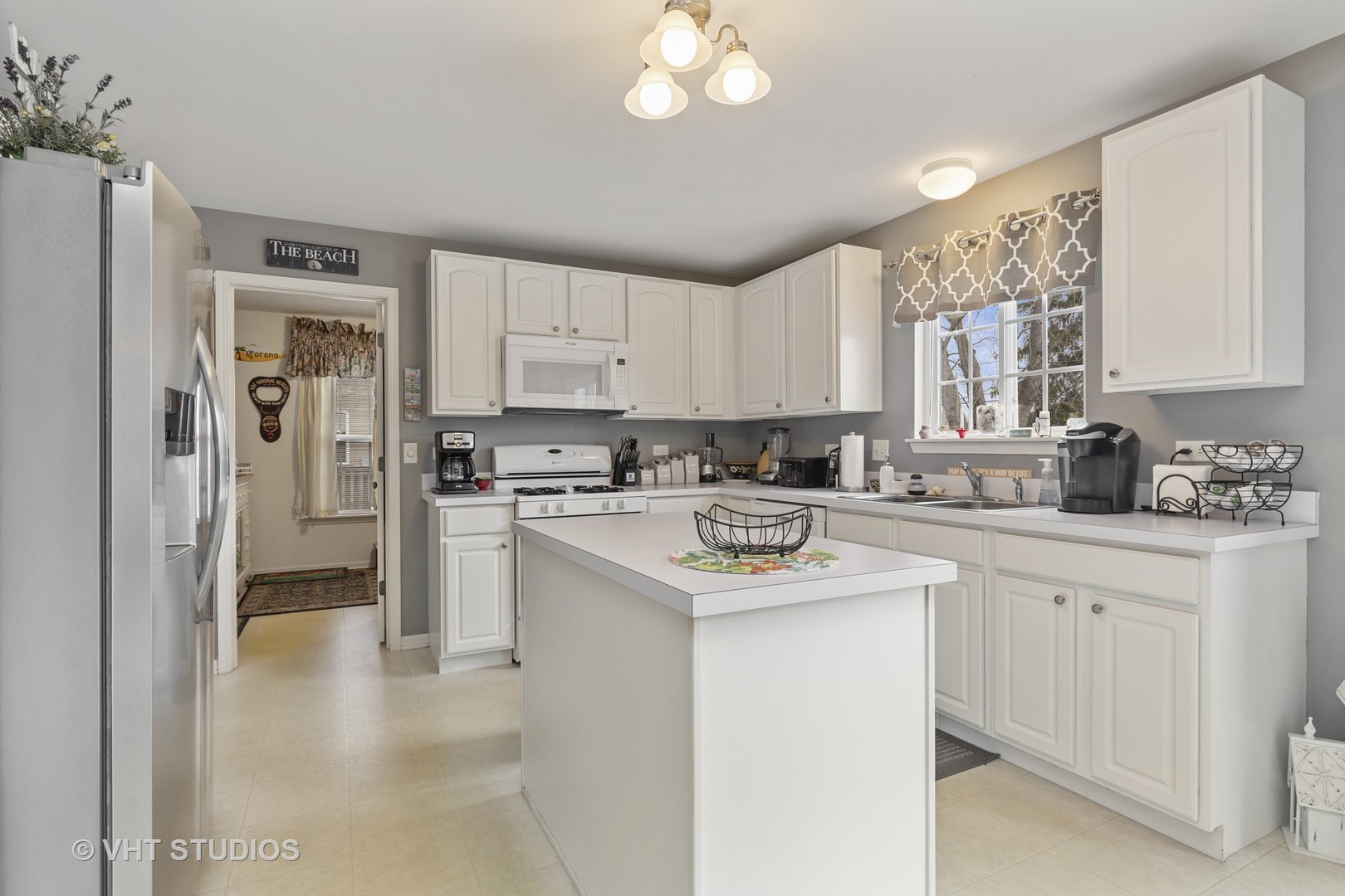 2621 Arbor Drive McHenry, IL 60050 - Photo 10 of 36 a kitchen with kitchen island white cabinets and white appliances
