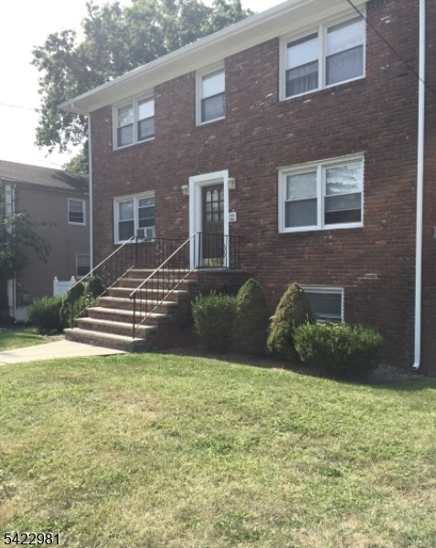 a view of a brick house with a yard