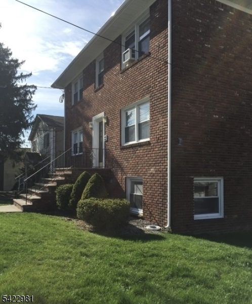 2116 Stanley Terrace, Unit 1 Union, NJ 07083 - Photo 2 of 7 a front view of a house with a yard