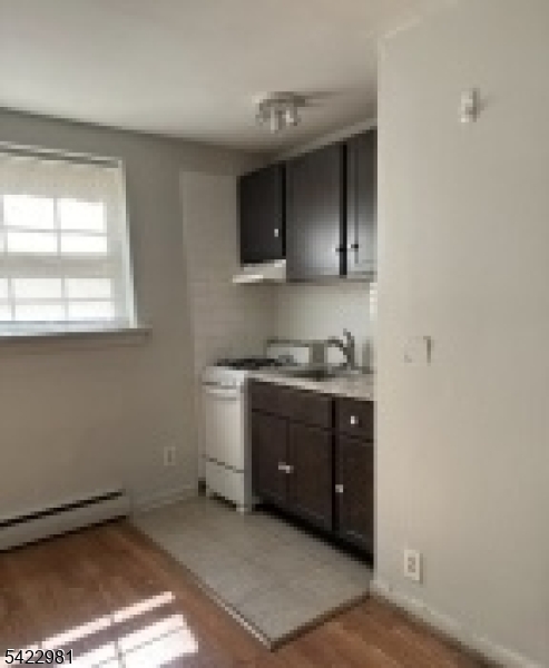 2116 Stanley Terrace, Unit 1 Union, NJ 07083 - Photo 6 of 7 a room with a sink cabinets and a window