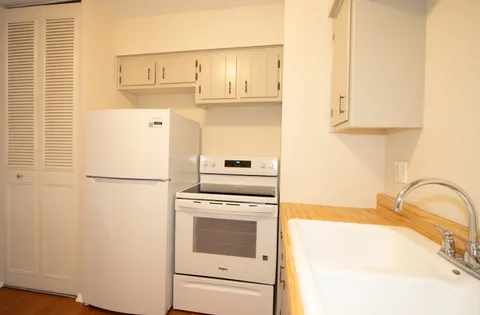 a kitchen with a white cabinets and white appliances