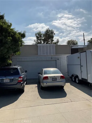 a view of a car parked in back yard