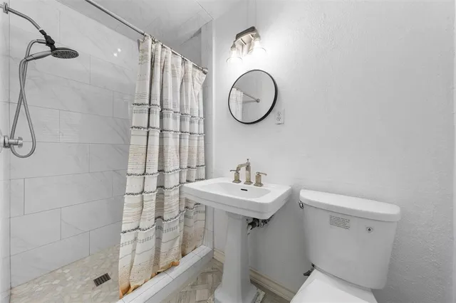a bathroom with a sink toilet and shower