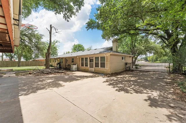 a view of a house with a yard and tree s
