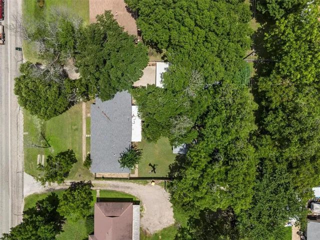 an aerial view of a house with a yard