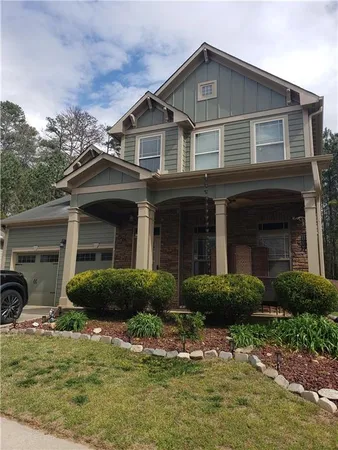 a front view of a house with garden