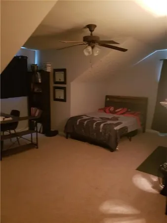 a bedroom with a bed and a chair