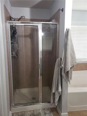 a bathroom with a glass shower door