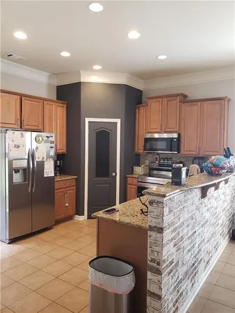 a kitchen with stainless steel appliances granite countertop a refrigerator stove top oven a sink and dishwasher