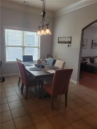 a view of a dining room with furniture and window